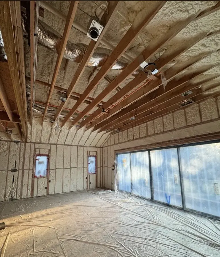 Interior walls and ceiling insulated with spray foam during new construction in Rochester